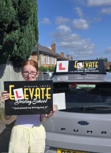 Happy student with driving instructor after passing their test quickly.