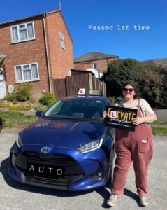 Another successful learner: driving instructor with student after passing final test.