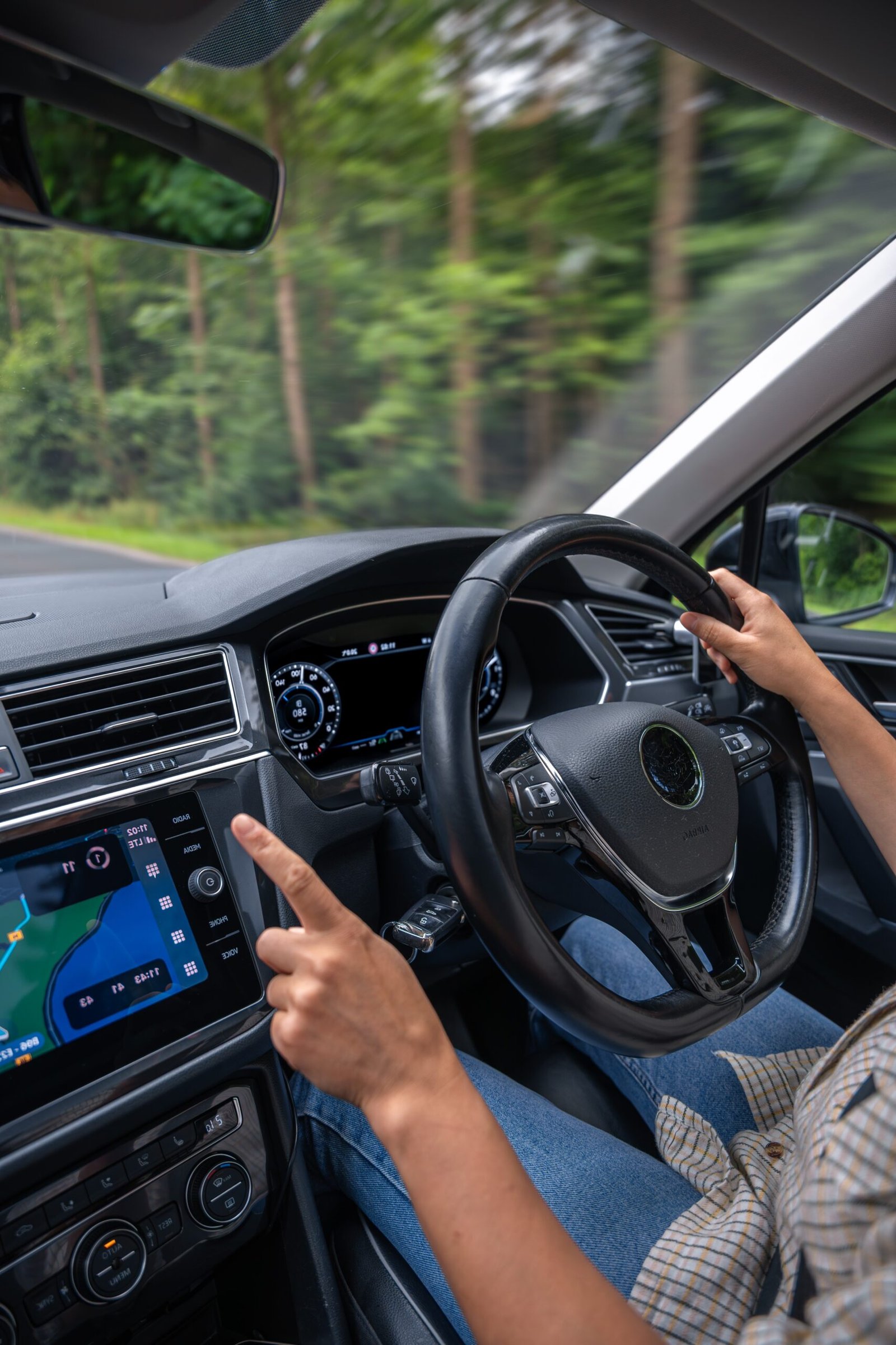 Semi intensive driving lesson close-up: student and instructor hands on wheel.
