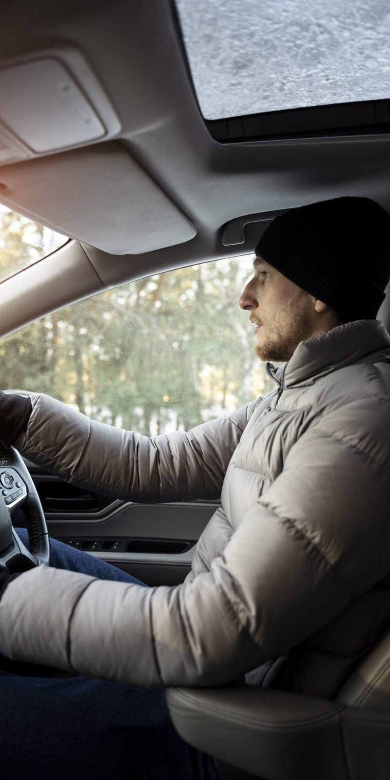 "Experienced driving instructor behind the wheel of a dual-controlled car.